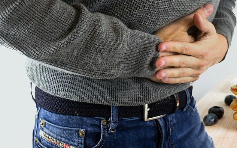 picture of man with intestinal discomfort for article on chiropractic and intestinal health